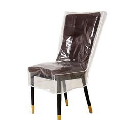 a clear plastic chair with black legs and gold trimmings on the back, against a white background