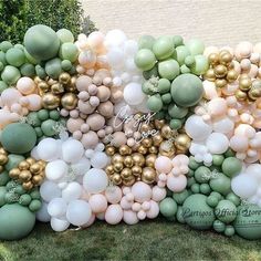 a bunch of balloons that are in the grass