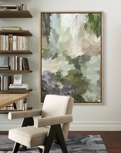 an abstract painting hangs on the wall above a chair in front of a bookshelf