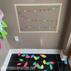 a hallway decorated with colorful lights and confetti on the floor next to a door