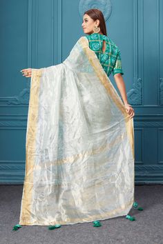 Look royal on weddings and festive occasions in this beautiful white tissue silk saree. It comes with a green bandhej saree blouse. White Slub Silk Dupatta, White Slub Silk Anarkali Dupatta, White Anarkali Slub Silk Dupatta, White Cotton Silk Pre-draped Saree For Festivals, White Slub Silk Dupatta For Eid, White Silk Pre-draped Saree For Festivals, Transitional White Saree With Sheer Dupatta, White Slub Silk Bollywood Dupatta, Green Tissue Silk Blouse Piece With Gota Work