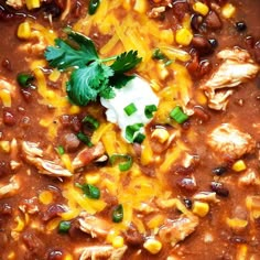 chicken chili with corn and sour cream in a pot