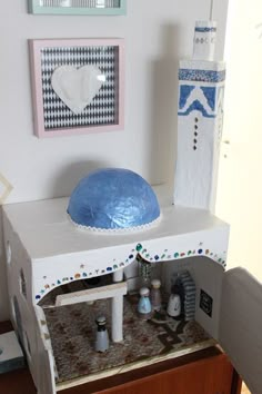 a doll house with furniture and accessories on display