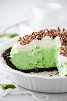 a cake with green frosting and chocolate shavings on it's side