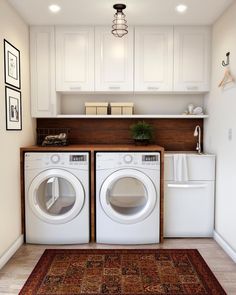 a washer and dryer in a small room with white cabinets on the wall