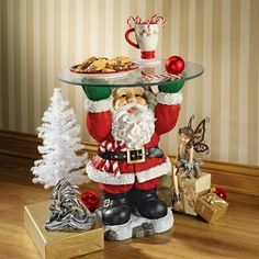 a santa clause holding a tray with cookies on it