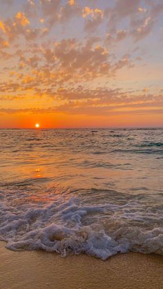 the sun is setting over the ocean with waves