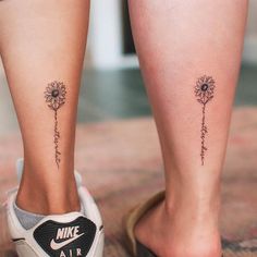 two small tattoos on the legs of people with flowers and words written in cursive writing