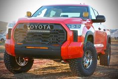 the front end of a red toyota pickup truck