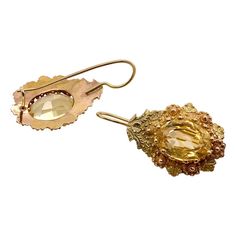 This is part of Chairish’s Fine Jewelry assortment.  A wonderful pair of Victorian period pierced earrings with a prong set citrine in the center.  The tear drop setting has Etrsucan beadwork alternating yellow and rose gold flowers.  The wires are French with a hook at the bottom.  They test 14K but have no marks.  Condition is excellent.  The citrines measure 10 mm X 8 mm, or 2.4 carats.  Dimensions: Length from top of wire, 1 1/4", The drop measures 1" by 5/8", Weight: 2.4 grams Elegant Formal Citrine Earrings, Fine Jewelry Citrine Earrings For Wedding, Citrine Wedding Earrings Fine Jewelry, Citrine Fine Jewelry Earrings For Wedding, Yellow Briolette Earrings For Formal Occasions, Citrine Drop Earrings For Wedding, Wedding Fine Jewelry Citrine Earrings, Elegant Oval Citrine Earrings, Elegant Teardrop Citrine Earrings