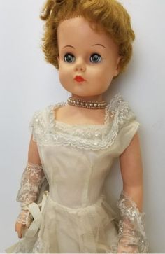 an old doll with red hair and blue eyes