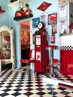 the interior of a diner with checkered flooring and red booths on the walls