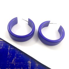 Cobalt Blue opaque lucite hoop earrings in a straight & sturdy shape with a shiny cobalt finish anda purple hue. This style is known as the 'Chandler Hoop' (formerly known as the Small Portland Hoop) and comes in 2 sizes. The larger one is the Portland Hoop. This is the smaller of the 2, but is in no way a small hoop. It measures about 30mm or 1.25" in diameter & 10mm in width. One of our favorite styles & comes in many colors. Jewelry is designed & hand finished by us, here in t Surgical Steel Earrings, Vintage Lucite, Purple Hues, Ring Holder, Vintage Earrings, No Way, Cobalt Blue, Post Earrings, Cobalt