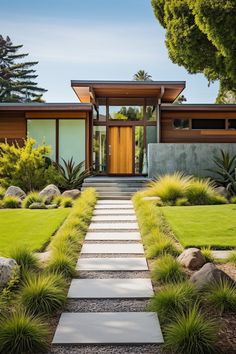 a modern house with grass and rocks in the front yard