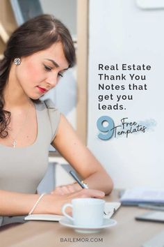 a woman sitting at a desk writing on a piece of paper with a pen in her hand