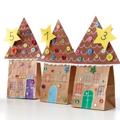 three paper bags with houses and stars on them