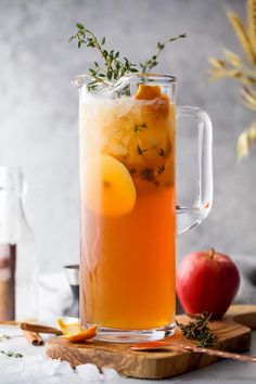 an apple cider is garnished with fresh herbs