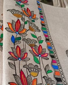 an embroidered cloth with flowers and leaves on it