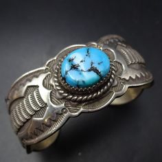 SIGNED VINTAGE NAVAJO BLUE KINGMAN TURQUOISE BRACELET DESCRIPTION:  With an abundance of hand-applied stamp work and a gorgeous specimen of natural blue Kingman turquoise, this bracelet will be a cherished addition to your collection of fine vintage Southwestern and Native American jewelry. MEASUREMENTS: Interior of the cuff measures 5 1/2" with an additional 1" slightly adjustable gap. Total circumference:  6 1/2" Measures 2 1/4" straight across the widest part  (from wrist bone to wrist bone) Classic Handmade Turquoise Bracelets, Vintage Blue Ceremonial Jewelry, Artisan Blue Stamped Bracelets, Bohemian Stamped Blue Bracelets, Artisan Blue Bracelets Collectible, Blue Stamped Bohemian Bracelets, Bohemian Blue Stamped Bracelets, Southwestern Engraved Blue Cuff Bracelet, Southwestern Style Stamped Blue Bracelets