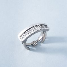 a close up of a silver ring on a white surface