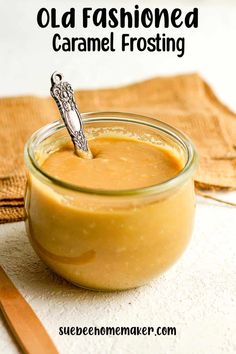 an old fashioned caramel frosting in a glass jar with a spoon sticking out