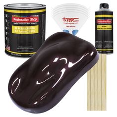 a mouse and some paint next to each other on a white surface with wooden sticks in front of it