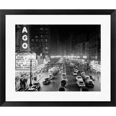 a black and white photo of traffic on a busy street at night in the city