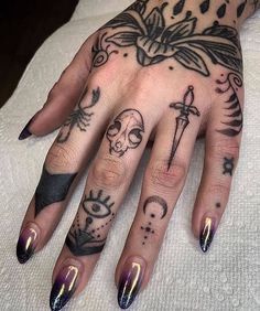 a woman's hand with tattoos on it