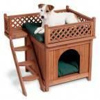 a dog laying on top of a wooden pet house