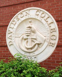 a sign on the side of a building that says madison college with a boat and anchor