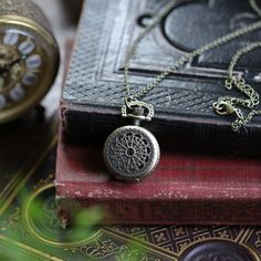 Small 25mm pocket watch necklace with a high quality quartz movement inside. On 26 inches of antiqued brass chain, attached with 2 little Victorian birds. I can make this chain any length for no extra charge. Just leave me a note at checkout! You can adjust the time by pulling up the knob and turning. Pressing the knob opens the watch. Each watch comes in a gift box with instructions and a spare battery. Antique Gold Metal Pocket Watch As Gift, Antique Gold Metal Pocket Watch Gift, Antique Gold Round Pocket Watch, Gold Pocket Watch With Antique Finish As Gift, Antique Finish Gold Pocket Watch, Gold Round Pocket Watch With Antique Finish, Vintage Metal Pocket Watch Nickel Free, Brass Round Pocket Watch As Gift, Brass Round Pocket Watch Gift