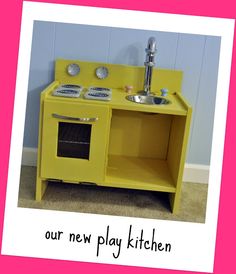 a yellow play kitchen with a sink and stove in the middle is featured on a pink background