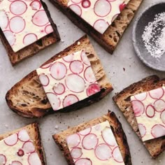 several slices of bread with cheese and radishes on them