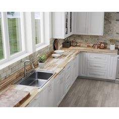 a kitchen with white cabinets and wooden counter tops, along with a stainless steel dishwasher