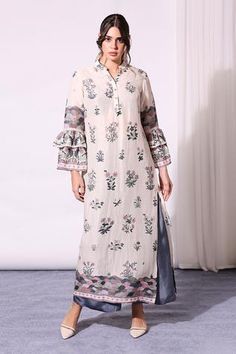 Off-white straight long kurta with floral motif print and layered bell sleeves. Comes with contrast palazzos.
Component: 2
Printed
Neckline: Band Collar
Sleeve Length: Full
Fabric: Linen, Twill
Color: White
Bell sleeves
Side slits
Button placket - Aza Fashions Kurta Sleeve Design, Tunic With Pants, Long Kurta, Printed Palazzo Pants, White Kurta, Indian Fashion Designers, Kurta With Pants, Printed Jumpsuit, Band Collar