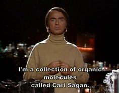 a man standing in front of a counter with an open hand on his chest and the words, i'm a collection of organic moleculess called carl sagan