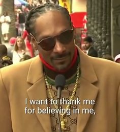 a man wearing sunglasses and a jacket with words written on it