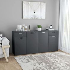 a living room with grey cabinets and white furniture