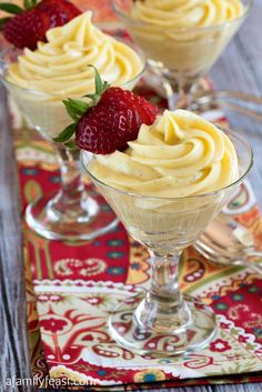 three desserts with strawberries in small glass dishes