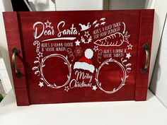 a red wooden sign with santa's list and other christmas related items on it