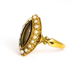 This spectacular antique mourning ring dates back to the late Victorian era. The centre of it's navette front is set with a glazed locket, bordered with black enamel and gold. The perimeter is lined with stunning white seed pearls. The shoulders have a beautiful ornate curving shape. Modelled in 18 karat yellow gold. Inside the band an inscription reads " J.M.F May 16th 1894.Ring Size: UK P 1/2, US 8Height: 20.9 mmWidth: 11.5 mm Luxury Victorian Oval Pearl Ring, Pearl Locket, Triple Band Ring, Antique Jewelry Rings, Romantic Rings, Yellow Gold Wedding Band, M F, Enamel Ring, Gold Wedding Band