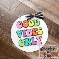 an ornament with the words good vibes only on it and a bow