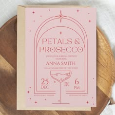 a pink wedding card with the words petals and prosceco printed on it