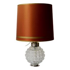 a table lamp with a red shade on it