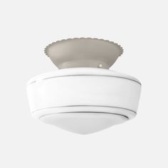 a white ceiling fixture with a scalloped shell on the top, and a light gray base