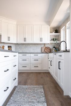 the kitchen is clean and ready for us to use it's white cabinetry