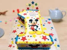 a mickey mouse birthday cake on a table