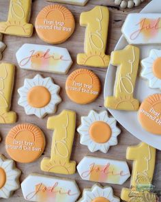 some decorated cookies are on a plate and next to other items that have been placed on the table