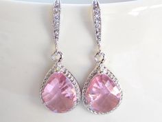 Stunning silver earrings featuring a beautiful  Pink color! These beautiful glass faceted beads are suspended from sparkly cubic zirconia ear wire. Absolutely gorgeous and elegant!***Pear shaped: 12x18mm (including loop)***Earrings measure approximately 32mm including the ear wire.***Polished Rhodium Frame*Each pair of earrings will be individually wrapped, ready for gift giving!IF YOU HAVE ANY QUESTIONS, PLEASE CONVO ME.Visit my shop at http://www.etsy.com/shop/florbridaljewelry******All jewelr Ligth Pink, Angel Wing Earrings, Orange Earrings, Jewelry Bridesmaid, Loop Earrings, Wing Earrings, Wedding Jewelry Earrings, Pink Earrings, Bridesmaid Earrings