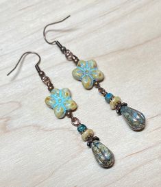 Everyday boho earrings perfect not only for spring and summer, but any time of year! These are created using Czech glass wild violet flower beads in beige with turquoise wash, opaque bluestone Czech glass teardrop beads with a platinum wash, small Czech tri-cut beads, small Czech disc beads, and antique copper accents.  Perfect for everyday, and make a lovely gift!  Total length of earrings, including the ear wire, is slightly over 2-1/2".    Thank you for shopping with The Lucie Collection! Handmade Bohemian Flower Earrings With Czech Glass, Handmade Bohemian Green Flower Earrings, Handmade Green Bohemian Flower Earrings, Handmade Czech Glass Flower Dangle Earrings, Bohemian Czech Glass Dangle Flower Earrings, Bohemian Blue Flower Earrings, Vintage Dangle Earrings For Beach, Adjustable Dangle Flower Earrings For Beach, Artisan Adjustable Drop Flower Earrings